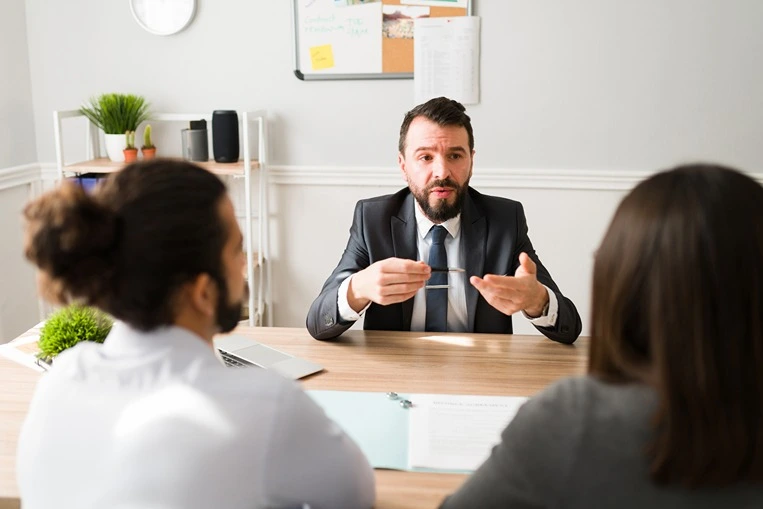 A couple consulting with a skilled Frisco no-fault divorce lawyer.